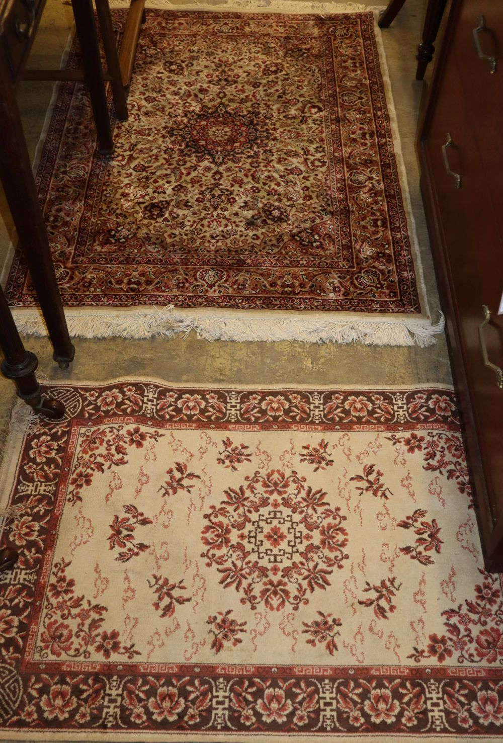 A Persian ivory ground rug and one other rug, larger 132 x 96cm